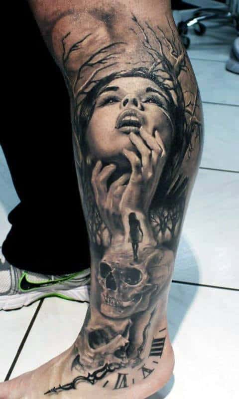 Leg tattoo with a woman's face, hands, trees, skull, clock, and a walking figure