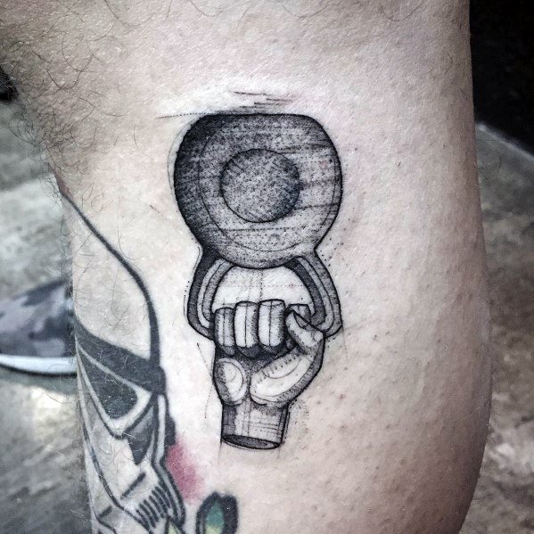 Detailed black and gray tattoo of a hand gripping a kettlebell, symbolizing strength, endurance, and dedication to fitness and weightlifting.