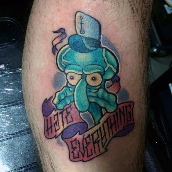 Bold Squidward tattoo with a grumpy face, sailor hat, and a banner that reads "Hate Everything" wrapped around the design.