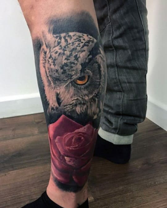 Leg tattoo with realistic owl above a red rose