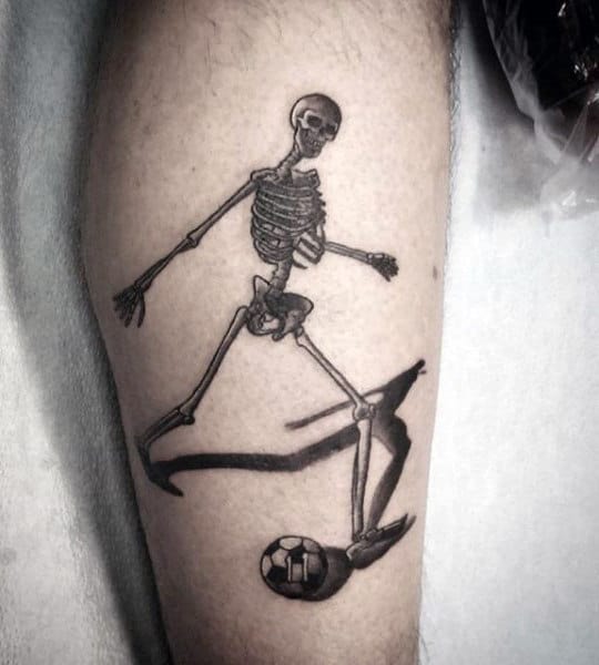 Leg Tattoo Of Skeleton Man Kicking Soccerball Guys Arm Tattoos