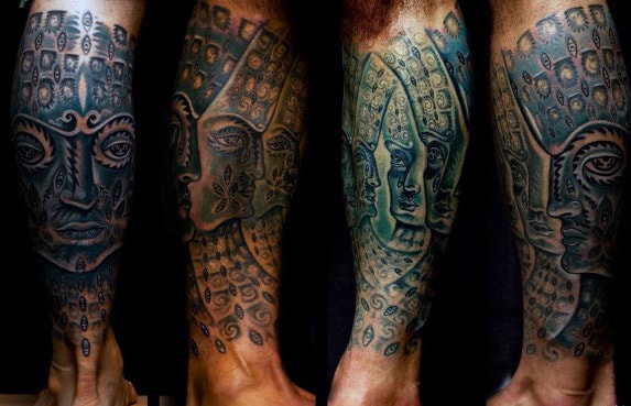 Legs with intricate, surreal tattoos of abstract faces and patterns
