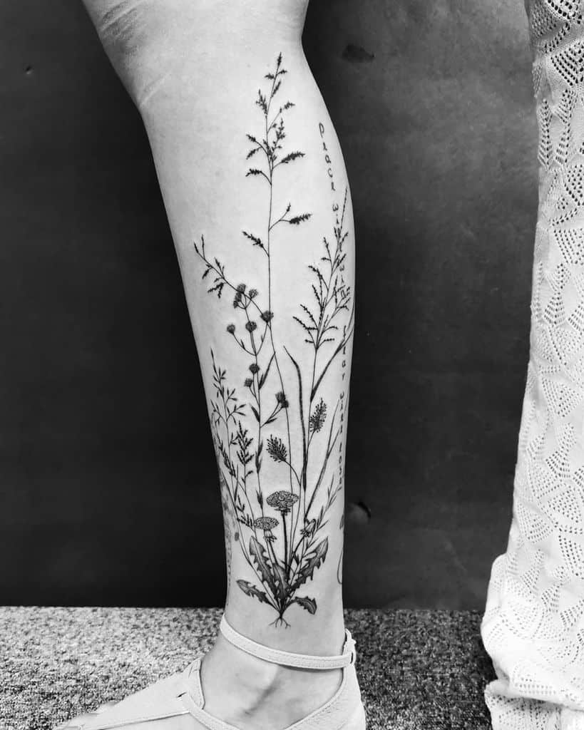 Leg tattoo featuring wildflowers and grasses