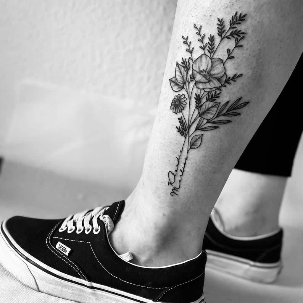 Minimalist leg tattoo of wildflowers with detailed leaves and stems, featuring delicate linework in black ink