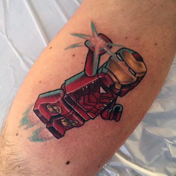 Colorful tattoo of Lego Iron Man flying with repulsor blasts and jet flames, showcasing dynamic motion and detailed armor design.
