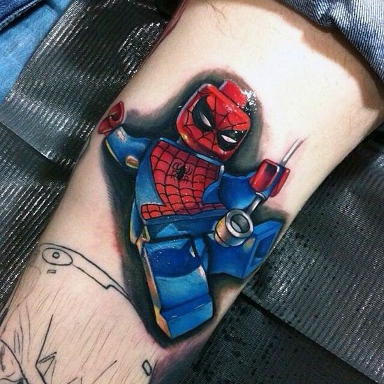 Bright and bold tattoo of Lego Spider-Man in an action pose, shooting webs with vivid red and blue colors and comic-style shading.