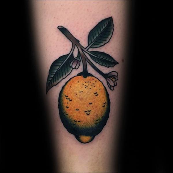 Traditional-style tattoo of a ripe lemon hanging from a branch with green leaves and small pink blossoms, outlined in bold black.