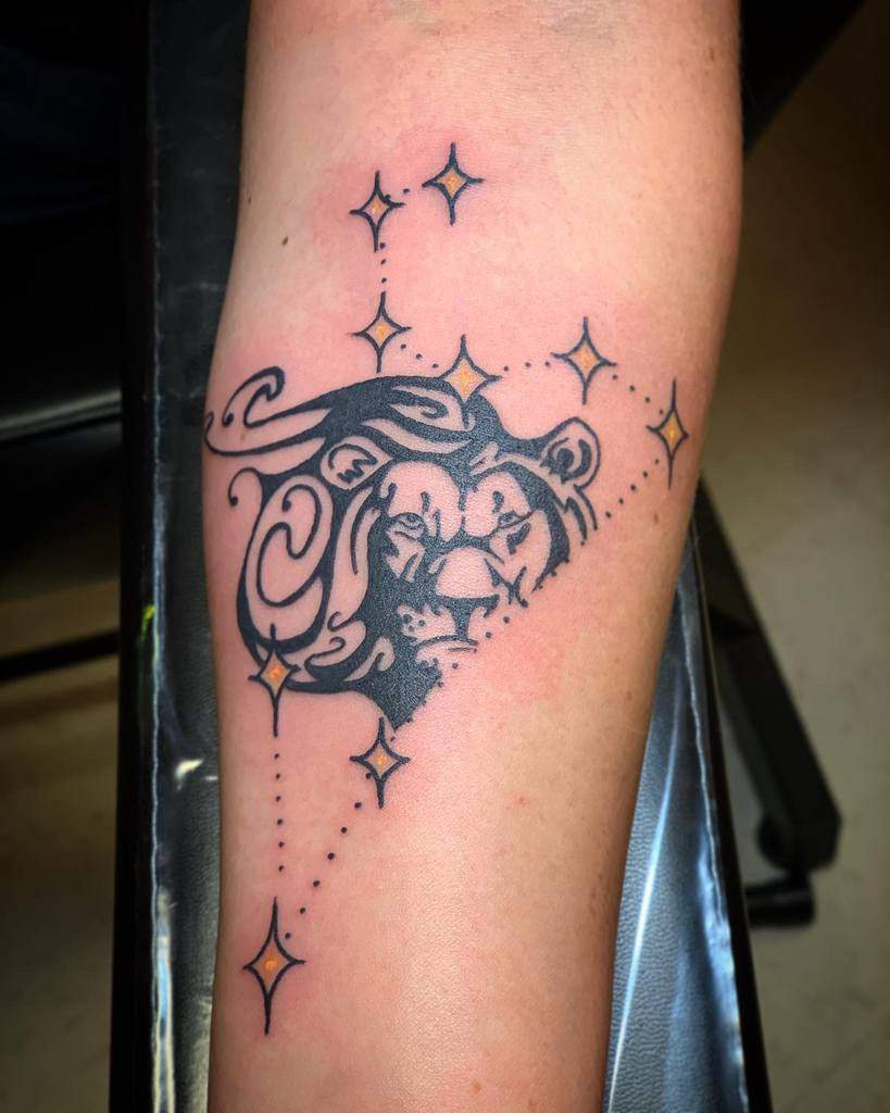 Artistic Leo zodiac tattoo with a fierce lion’s face, accented by glowing stars and a flowing cosmic mane.