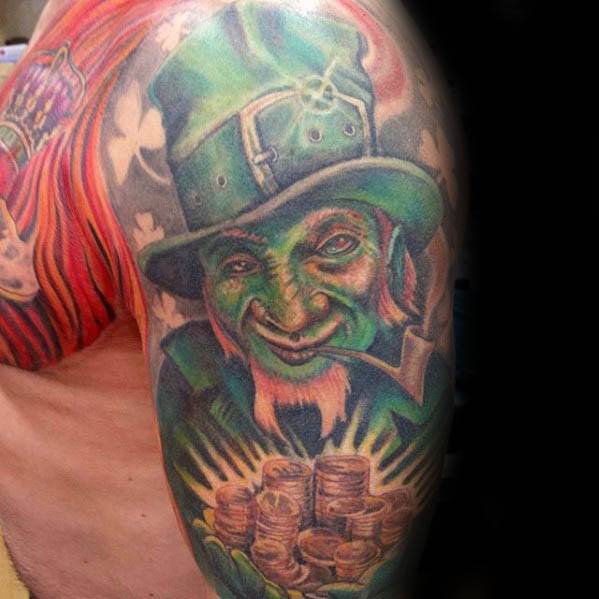 Colorful leprechaun tattoo with glowing green skin, smoking a pipe, and holding a shining pile of gold coins with shamrocks in the background.