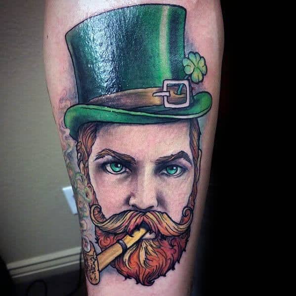 Leprechaun tattoo with piercing green eyes, fiery beard, green top hat, and a smoking cigar wrapped in gold foil.
