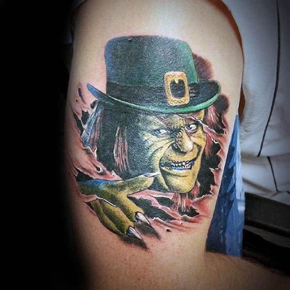 Creepy leprechaun tattoo with green skin, long nails, and an evil grin, tearing through the skin while wearing a dark green hat with a gold buckle.