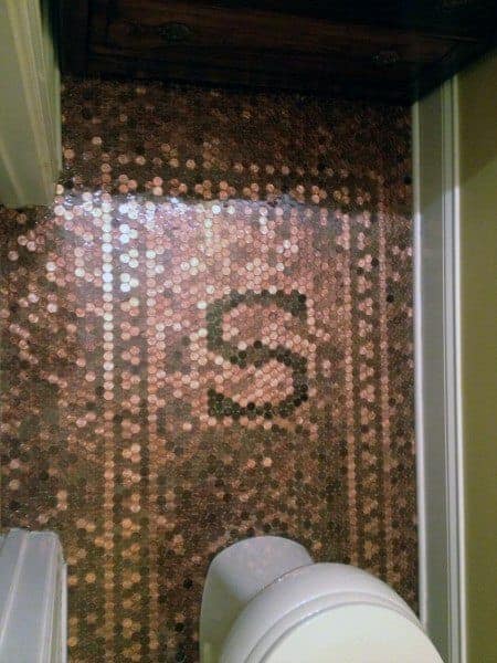 Bathroom with penny tile floor featuring a bordered design and a prominent letter "S" centerpiece.
