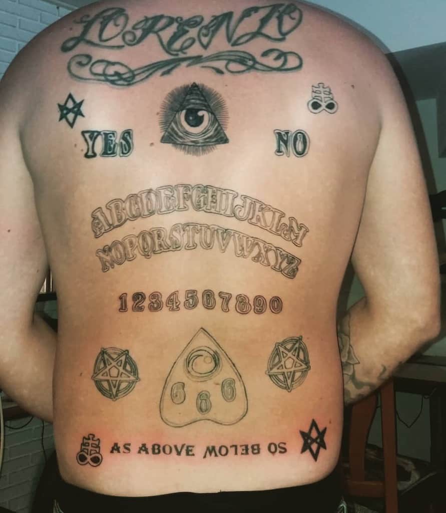 Back tattoo with spiritual elements including 'As Above So Below,' an eye symbol, pentagrams, and Ouija-inspired lettering, conveying mystical themes