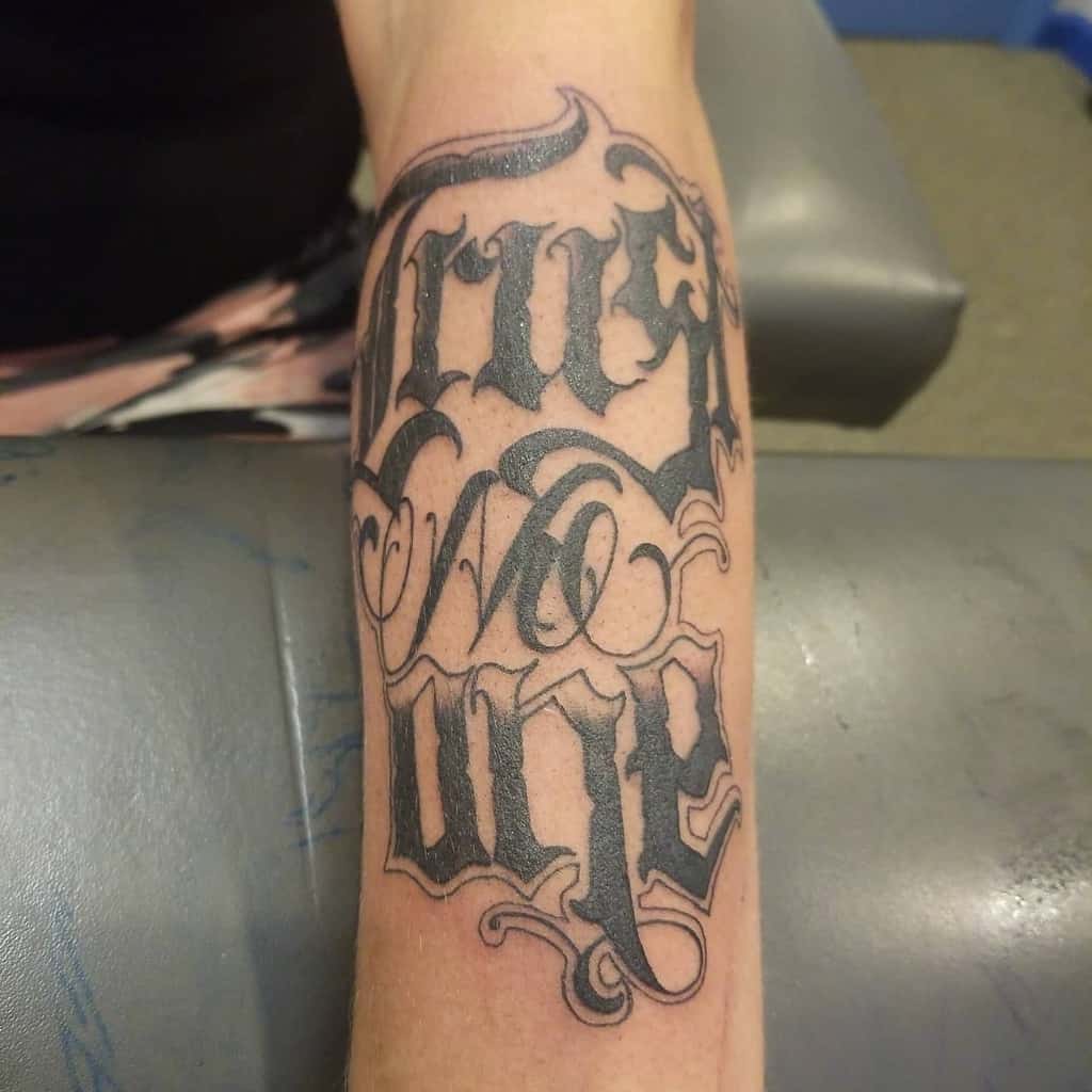 Tattoo on forearm reading "Trust No One" in bold script