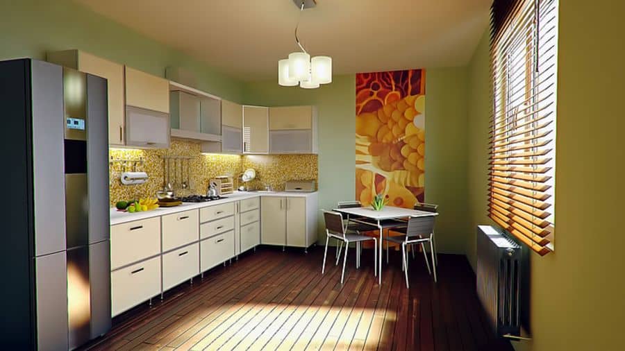 Bright kitchen with light green walls, modern cabinetry, warm wooden flooring, and a colorful accent wall.