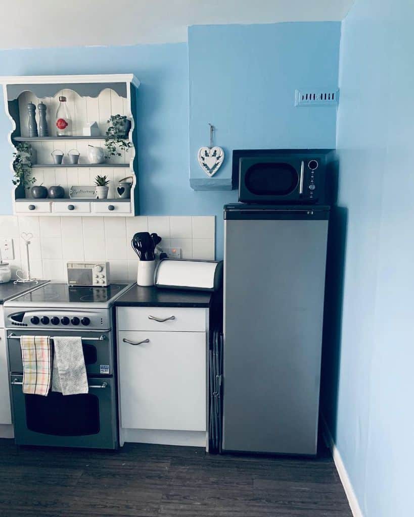 blue accent wall country style kitchen