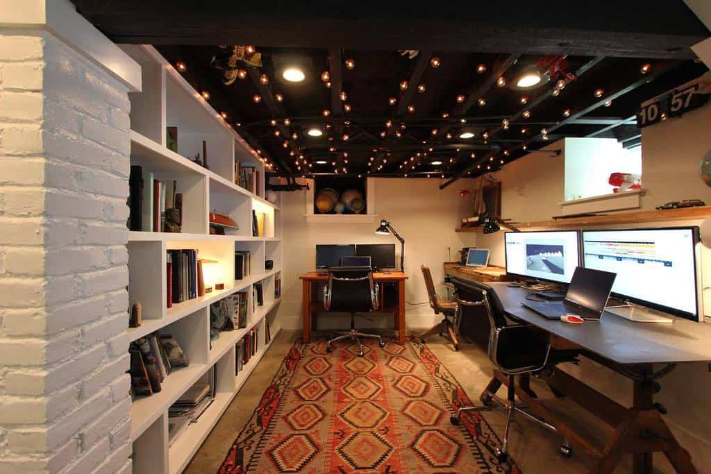 low ceiling office space with wall length bookshelf