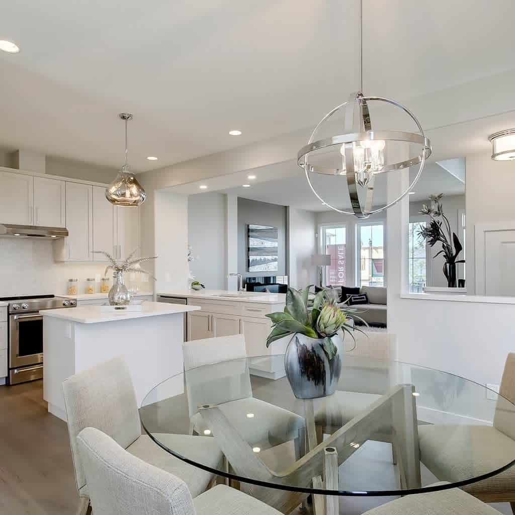 modern open plan kitchen dining and living room circular glass table unique ceiling light fixture