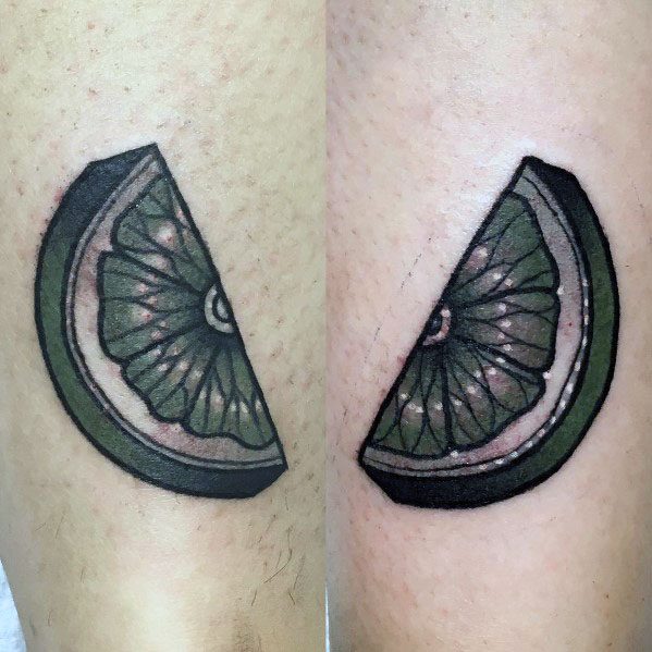 Bold lime wedge tattoo with dark green shading and a thick black outline, creating a striking and detailed citrus-inspired design.