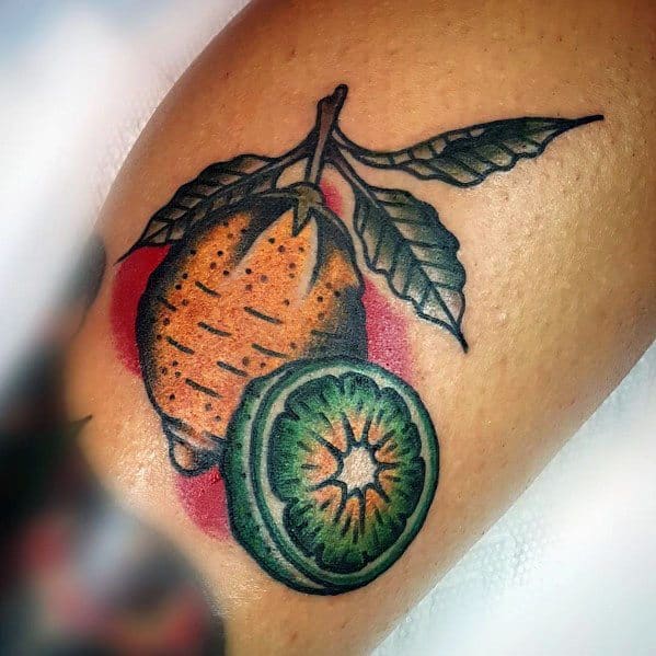 Bold citrus tattoo featuring a detailed lemon and a vibrant lime slice, with rich shading and a classic traditional style design.