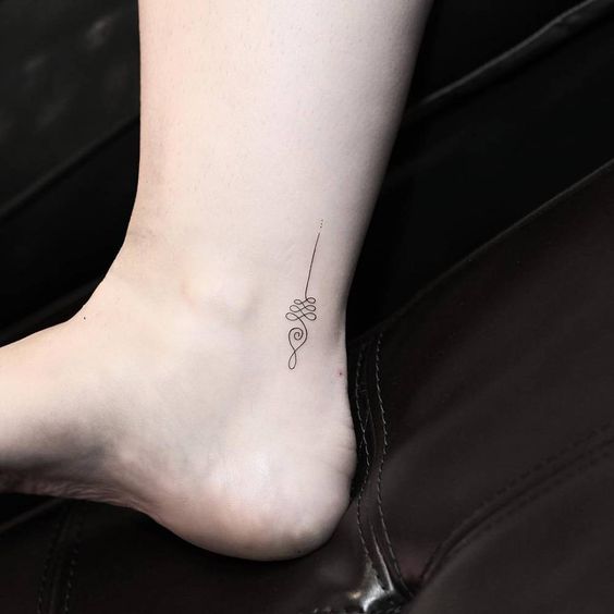 Delicate Unalome tattoo on the ankle, symbolizing life's journey, personal growth, and the path to spiritual enlightenment.