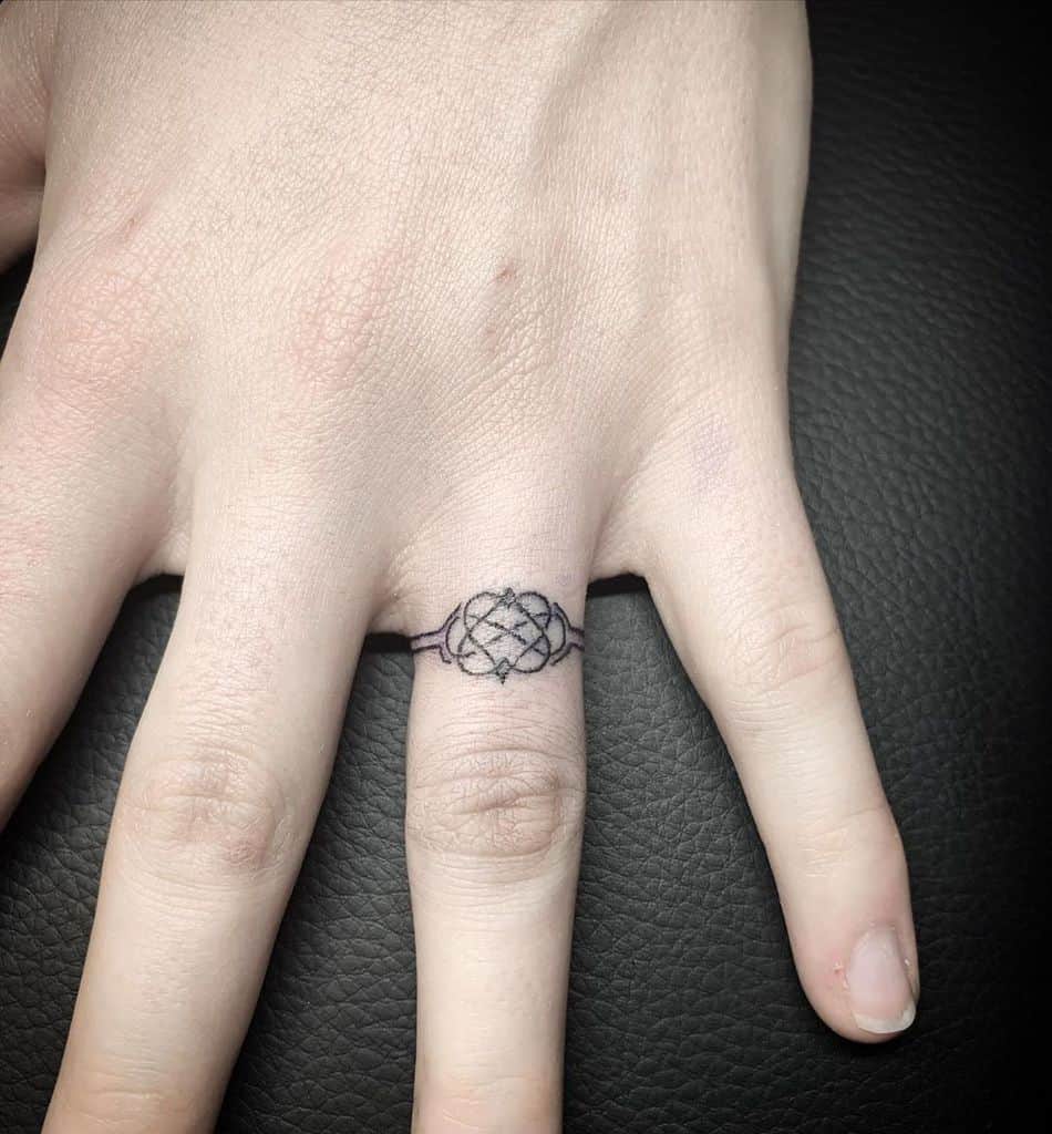 A minimalist ring tattoo featuring an intricate knot design, resembling a decorative band