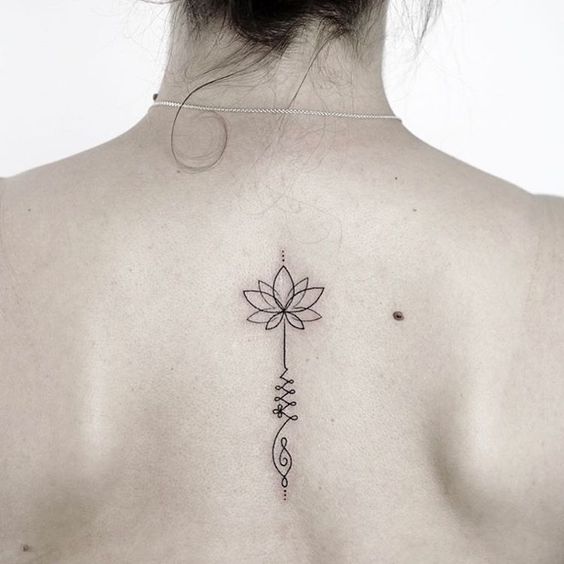 Unalome tattoo with a lotus on the upper back, symbolizing spiritual enlightenment, growth, and the journey to inner peace.