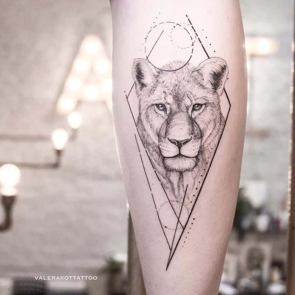 Elegant lioness tattoo on the leg, featuring fine linework, geometric shapes, and dotwork shading for a modern and minimalist look.