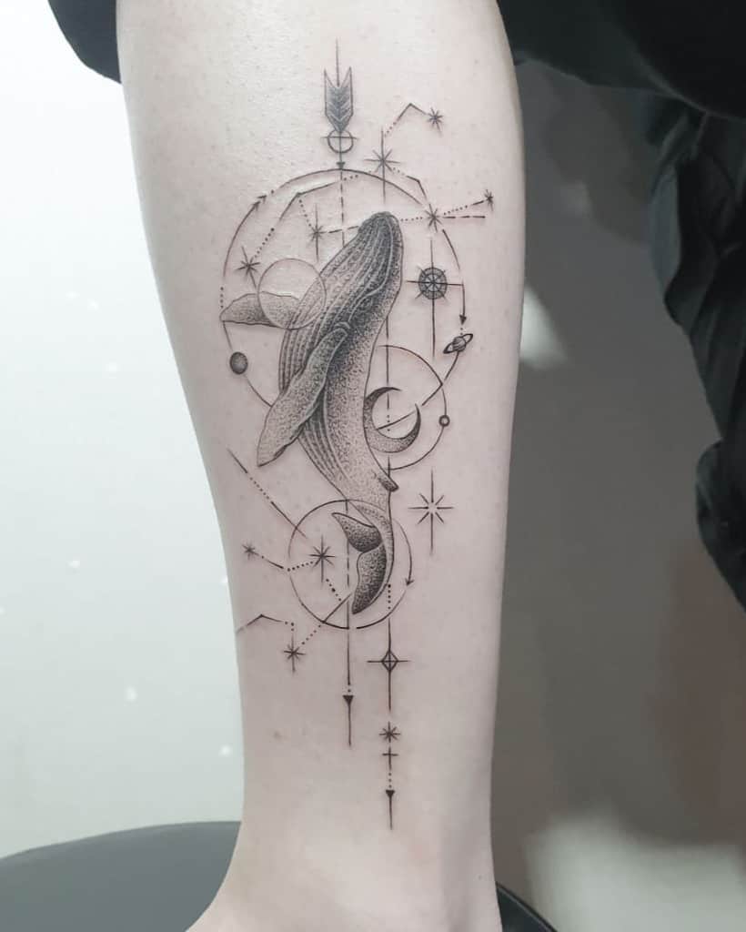 Mystical whale tattoo with geometric and celestial symbols, representing wisdom, guidance, and the universe.