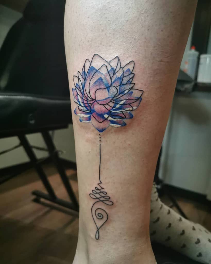 Unalome tattoo with a vibrant blue and pink lotus on the leg, symbolizing spiritual awakening, growth, and the journey to enlightenment.