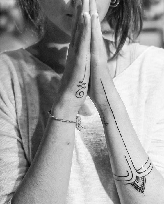 Minimalist Unalome tattoo on the hand and geometric forearm design, symbolizing spiritual growth, balance, and inner peace.