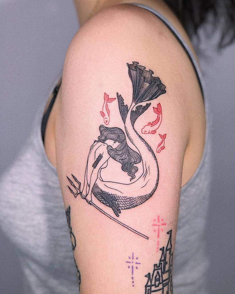 Delicate black and red tattoo of a mermaid curled around a trident, surrounded by small fish and magical castle elements.