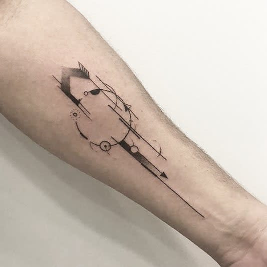 Forearm tattoo featuring an abstract geometric arrow with fine lines and circular elements, creating a sleek and modern minimalist design.