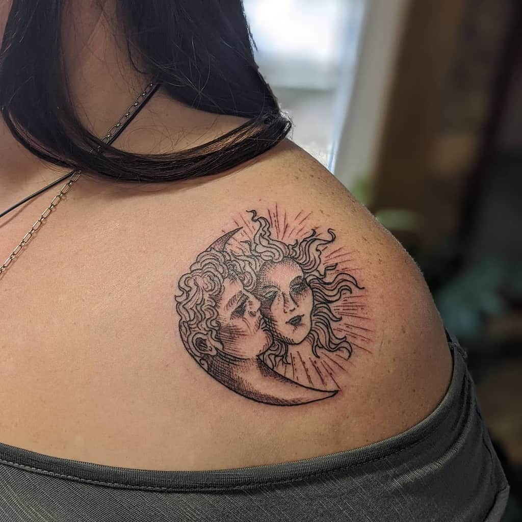 Black ink tattoo of a crescent moon with a male face embracing a radiant sun with a female face, featuring fine line shading and celestial details.