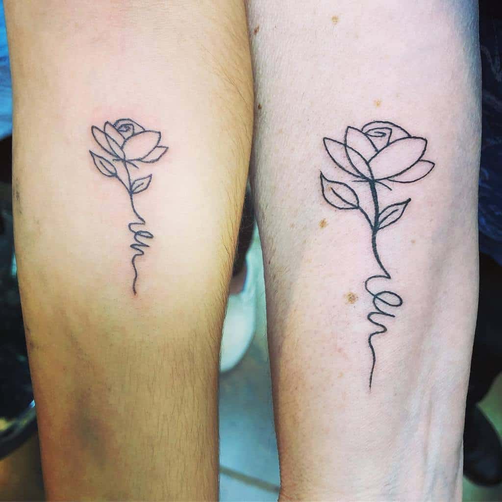 Two forearms with matching rose line art tattoos