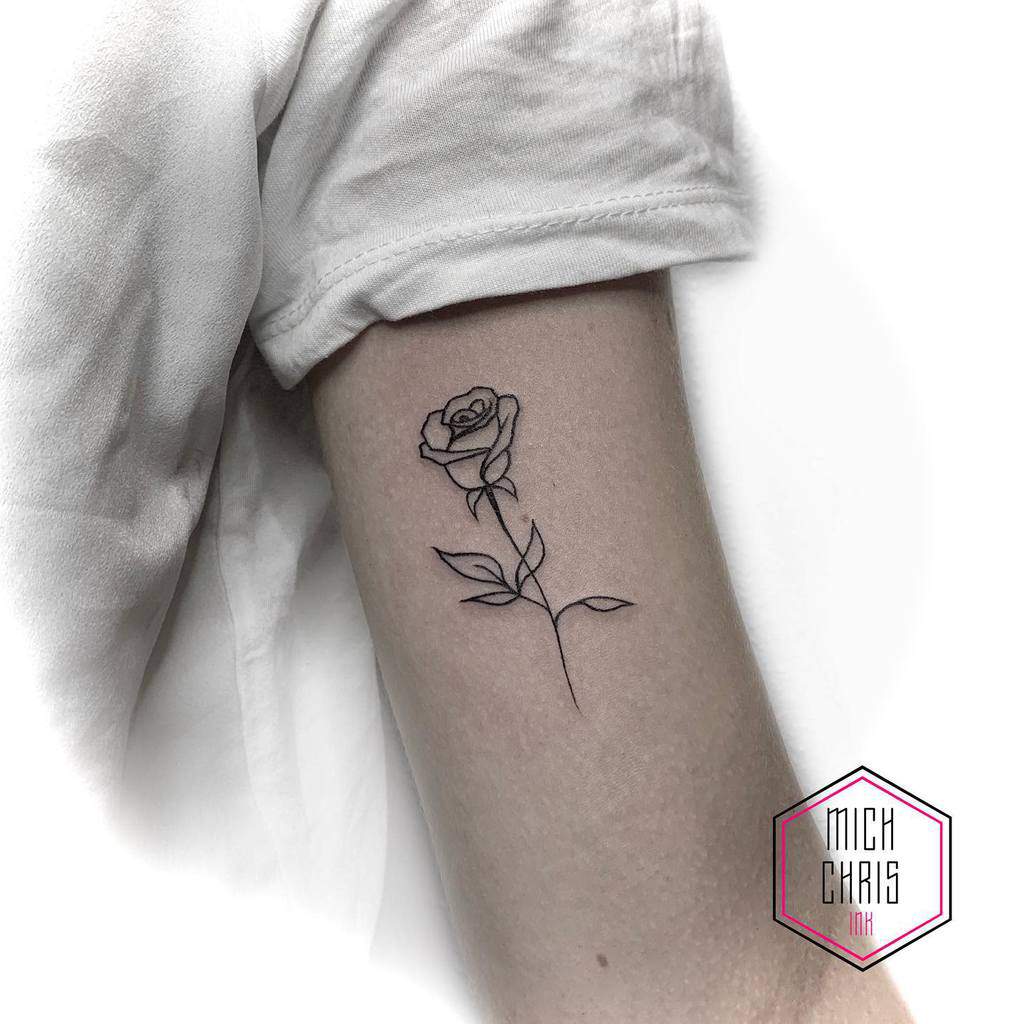 Outline of a rose tattoo on an arm 