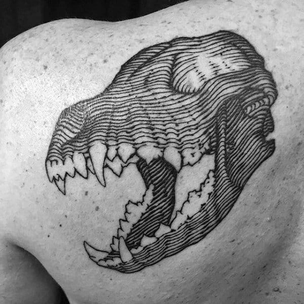 A striking black and white tattoo of a snarling wolf skull graces the person's shoulder, exuding a sense of fierce elegance