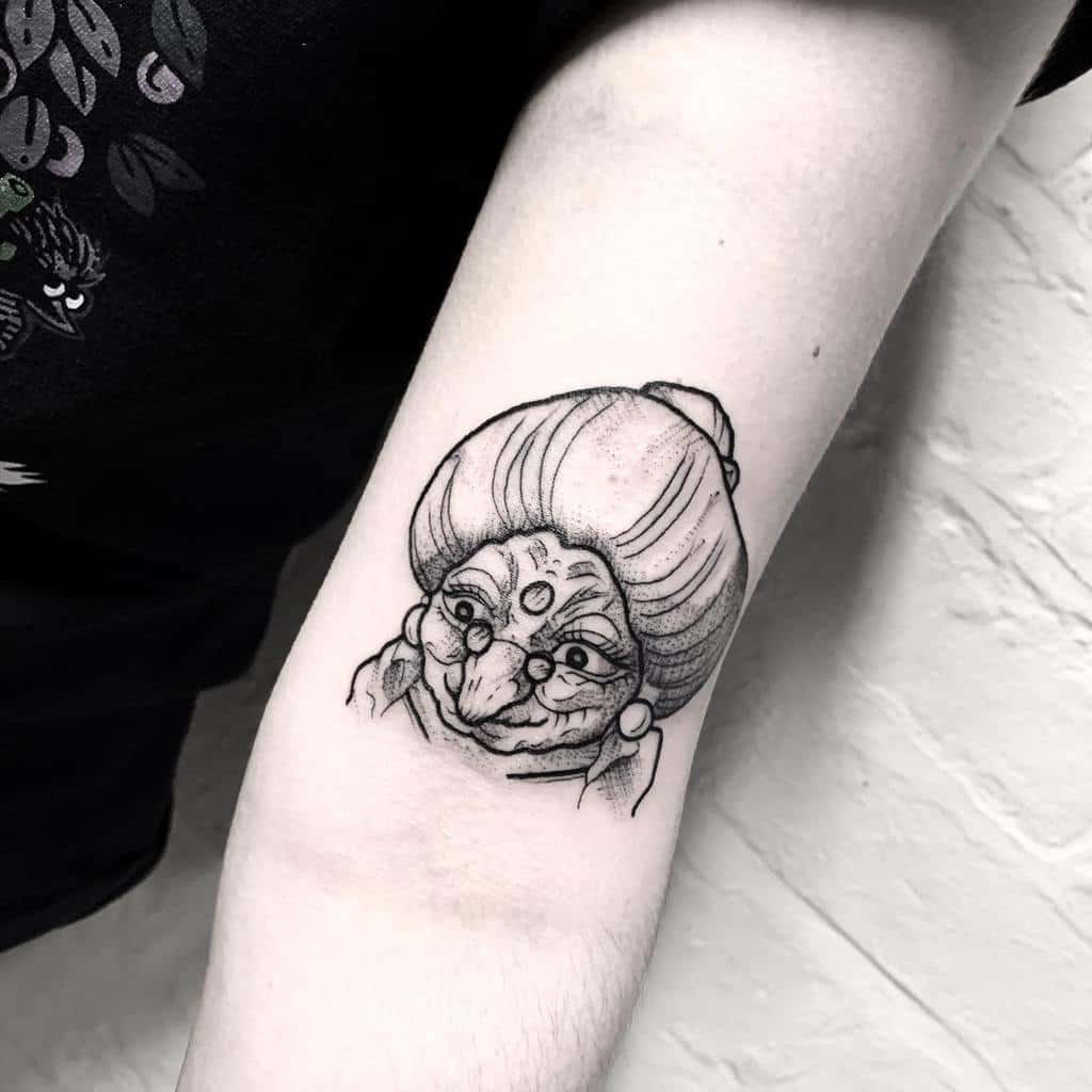 Black and grey tattoo of Yubaba from Spirited Away, featuring fine linework, expressive shading, and detailed facial features
