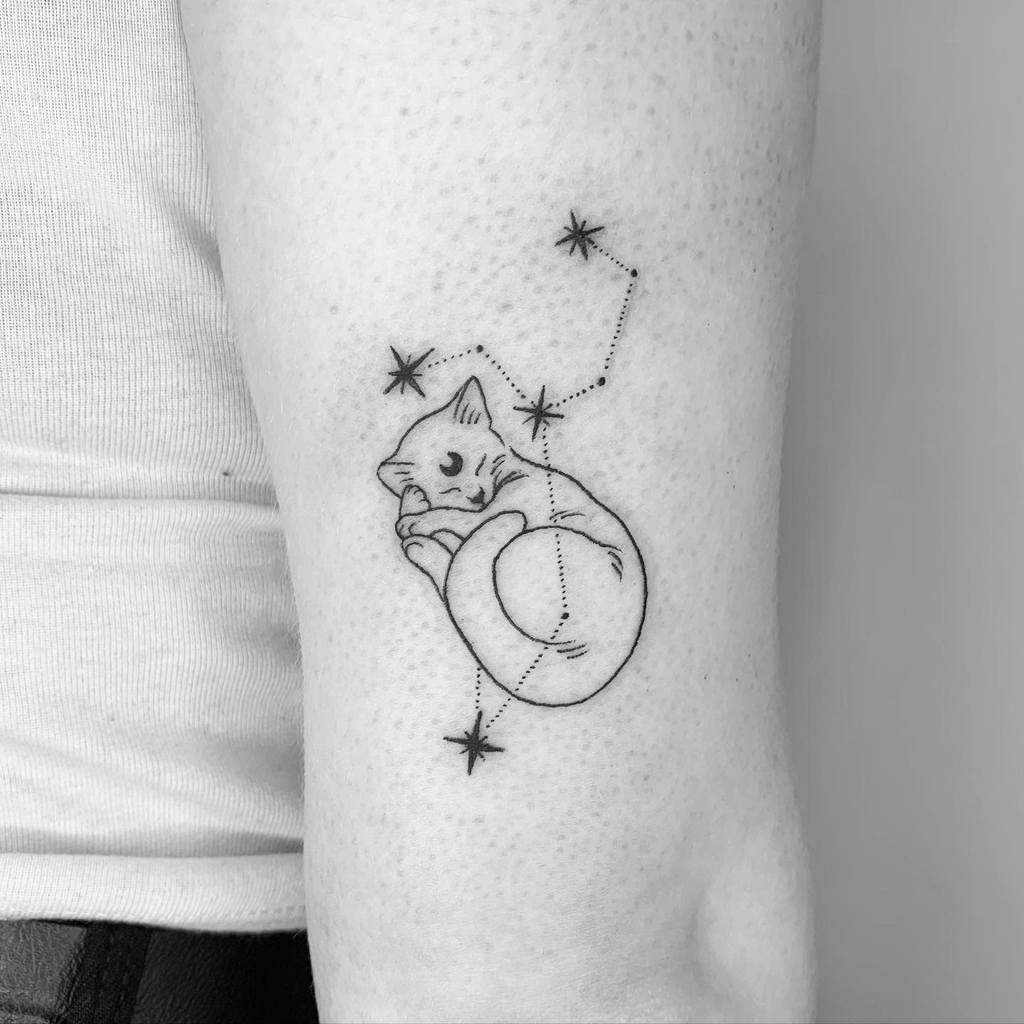 Minimalist tattoo of a sleeping cat curled into a ball, integrated with the Leo constellation for a cosmic touch.