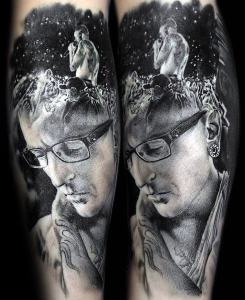 Hyper-realistic black and gray tattoo of Chester Bennington, blending a thoughtful portrait with a live performance scene above his head.