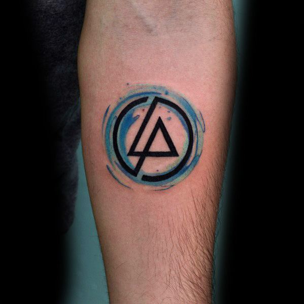 Bold black Linkin Park logo tattoo with a blue watercolor swirl effect, creating a vibrant and artistic design on the forearm.