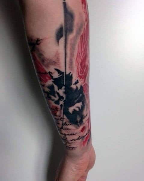 Linkin Park-inspired tattoo featuring a grunge-style soldier with a flag, red brushstroke background, and handwritten lyrics on the forearm.