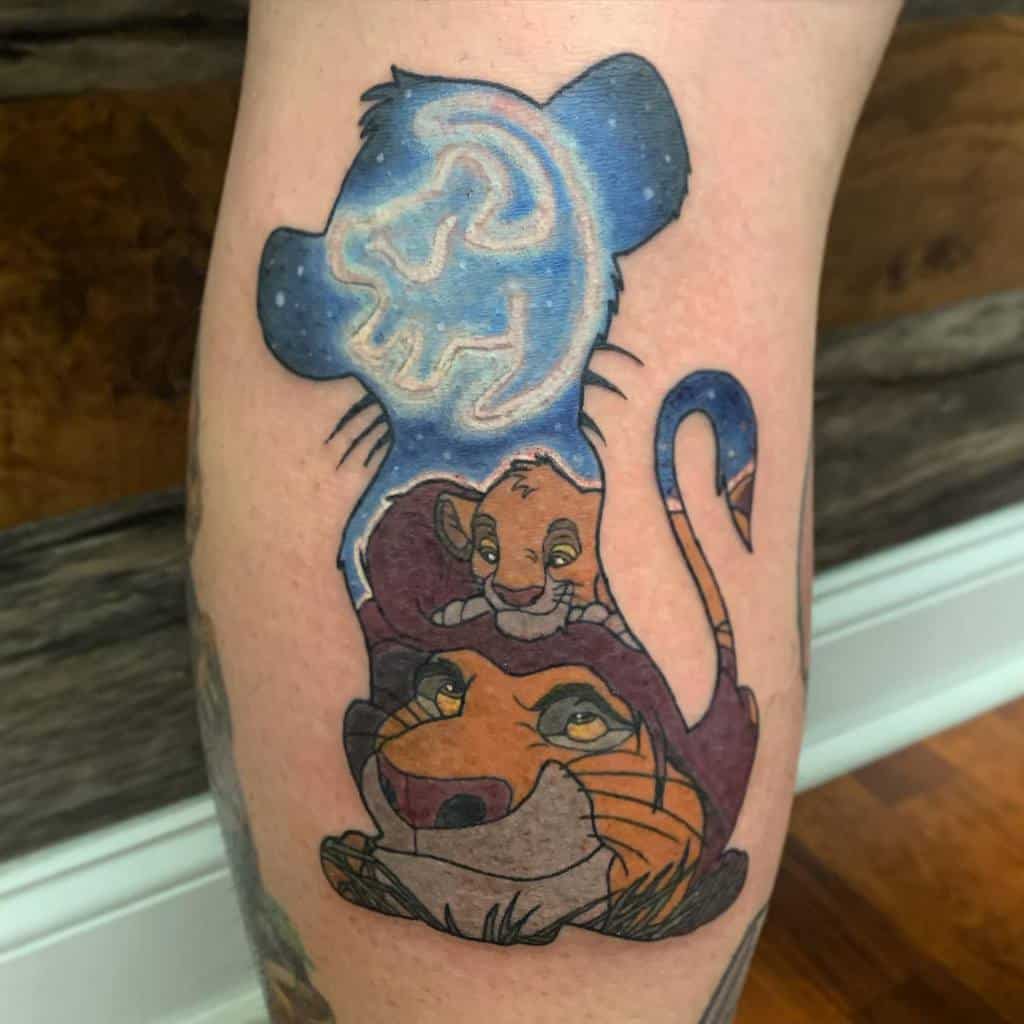 Vibrant tattoo featuring Simba and Mufasa with the glowing image of tiny cub, inside a silhouette of Simba
