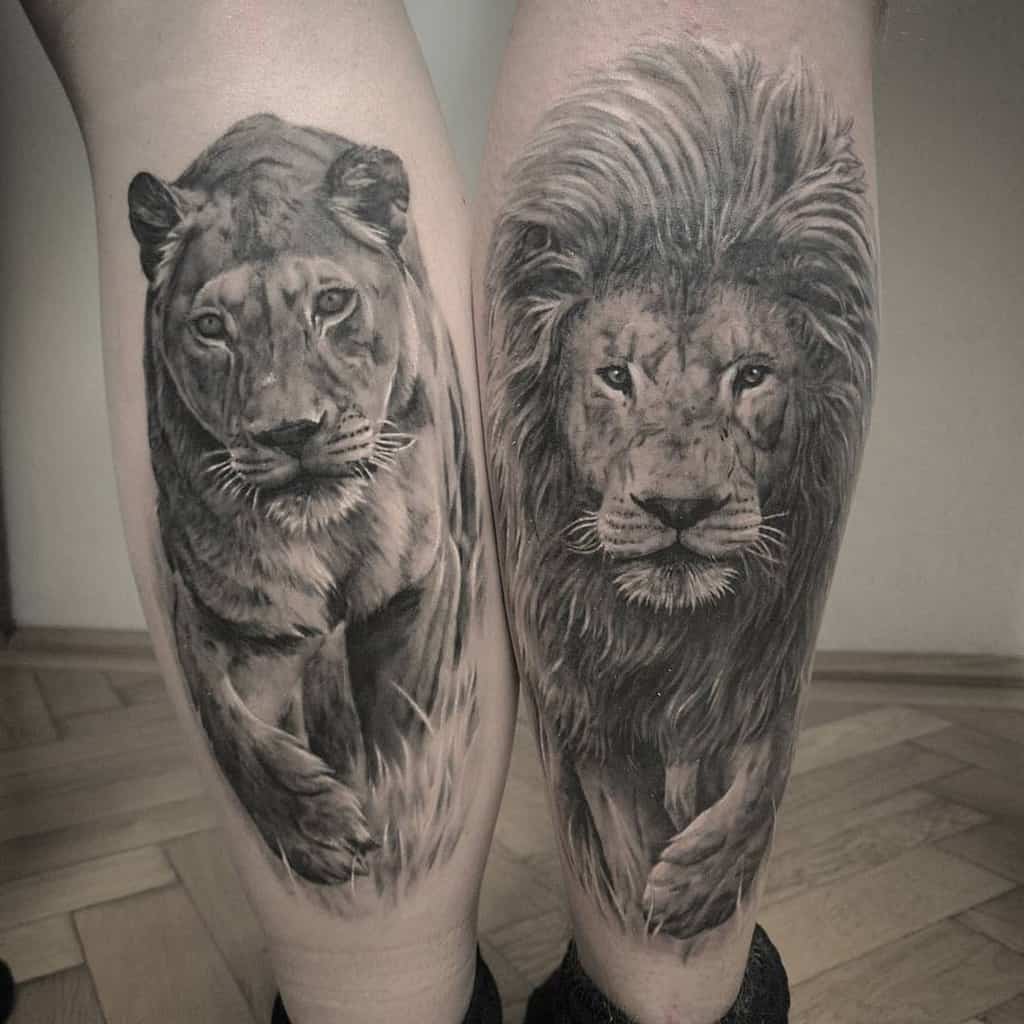 Hyper-realistic lion and lioness tattoos on the calves, featuring intricate shading, lifelike fur details, and a powerful, dynamic stance.