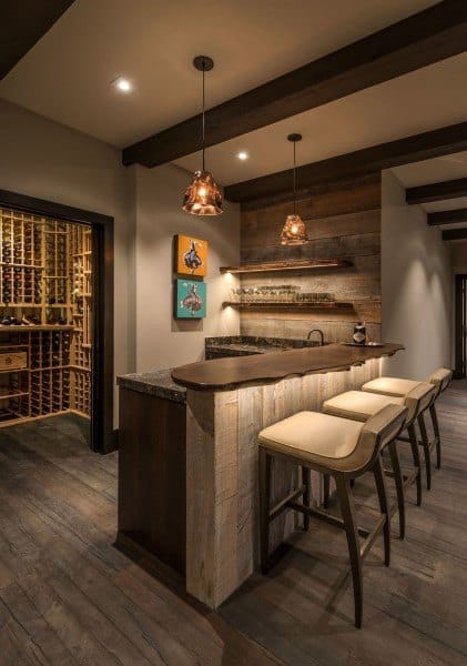 Rustic wood slab bar top with modern pendant lighting and cozy seating in a wine-themed space.