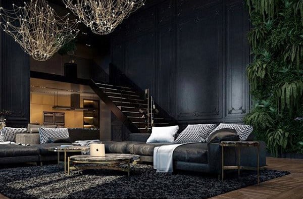 Luxurious living room with dark walls, modern chandeliers, and large sectional sofa.