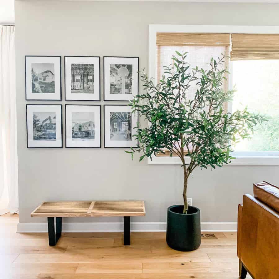 minimalist living room with wood bench seat and framed wall art 