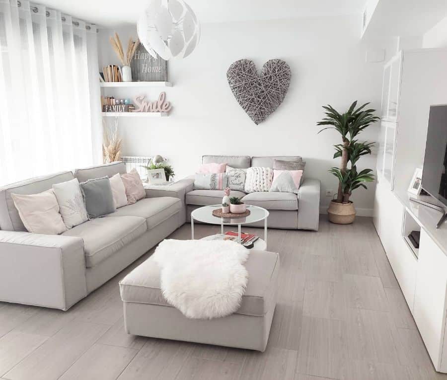 minimalist neutral living room with wood flooring and gray sofas