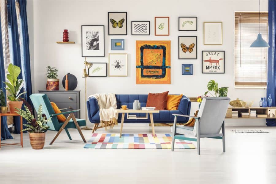 vintage style living room with framed wall art and blue sofa 