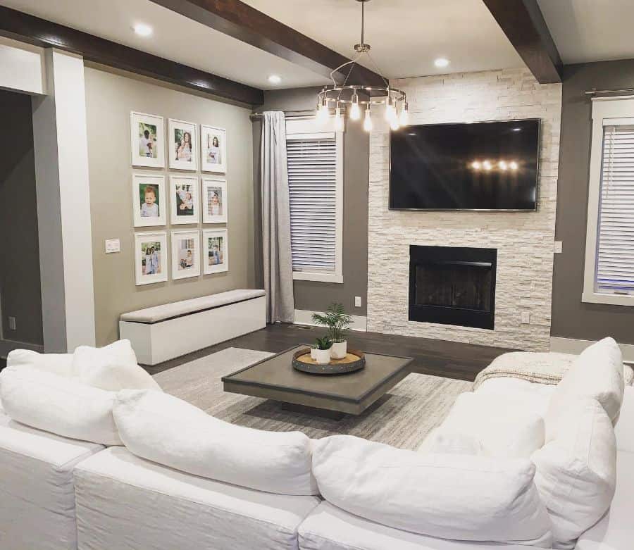 farmhouse style living room with white sofa and stone fireplace 